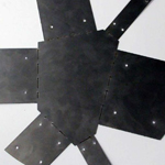 Photograph of a cut and scored metal sheet.