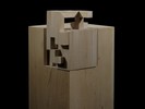 Photograph of bass wood cube model on base with shifted portions of the cube.