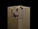 Photograph of bass wood cube model on basewith shifted portions of the cube.