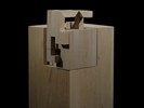 Photograph of bass wood cube model on basewith shifted portions of the cube.