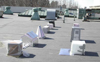 A photo of nine miniture house projects on a rooftop.