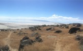 A photo of the beach and shoreline leading up to the art installation, The Spiral Jetty.