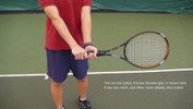 Here, the left hand grips the racket above the right hand, with the palm facing the net.
