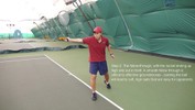 At the end of the stroke, the racket is held outstretched at shoulder level, pointing directly upwards, in the right hand.