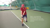 Both hands swing the racket around to hit the ball, straightening both elbows.