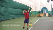 The left hand moves straight up and releases the ball at the top of the motion, and the right hand brings the racket up behind the head, ready to hit the ball.