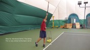 Stepping forward on the left foot, the right hand swings the racket up and over the head to meet the ball as it falls.