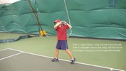 After the stroke, the racket is held high over the left shoulder, with weight on the right foot.