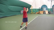The left hand comes up again to steady the racket at the end of the stroke.