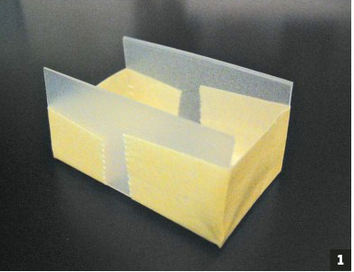 Photo of rectangular plastic container with ends cut off and taped over.
