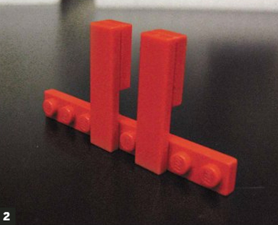 Photo of Lego block assembly, in the shape of a 'T' with two uprights.