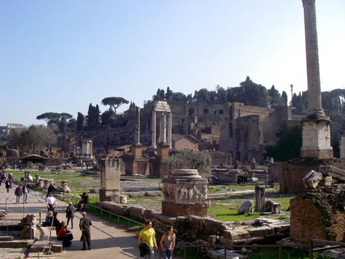 Photo of tourists walking among Roman ruins.