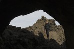 Student framed by rock formation.