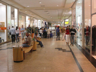 A photo of a crowded shopping mall hallway.