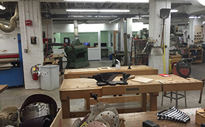 Open space filled with workbenches and tools.
