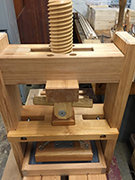 Image of a printing press made out of wood.