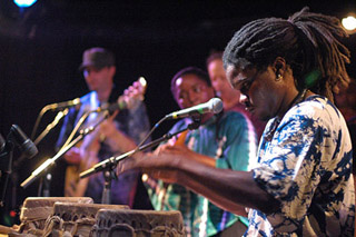 Photo of Lamine Toure performing on the sabar.