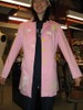 A pink thigh-length jacket features scattered clouds, a sheep holding the string of a balloon in its teeth, and white dot edging at the sleeves, pockets, and along the bottom hem.