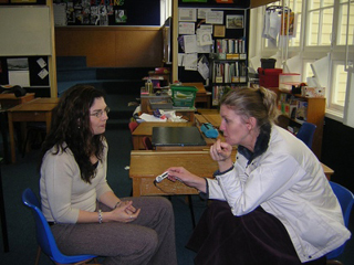 Photograph of one person interviewing another.