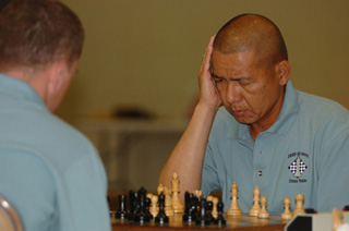 A photograph of two men playing chess.