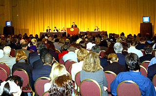 Speaker presenting to a large audience.